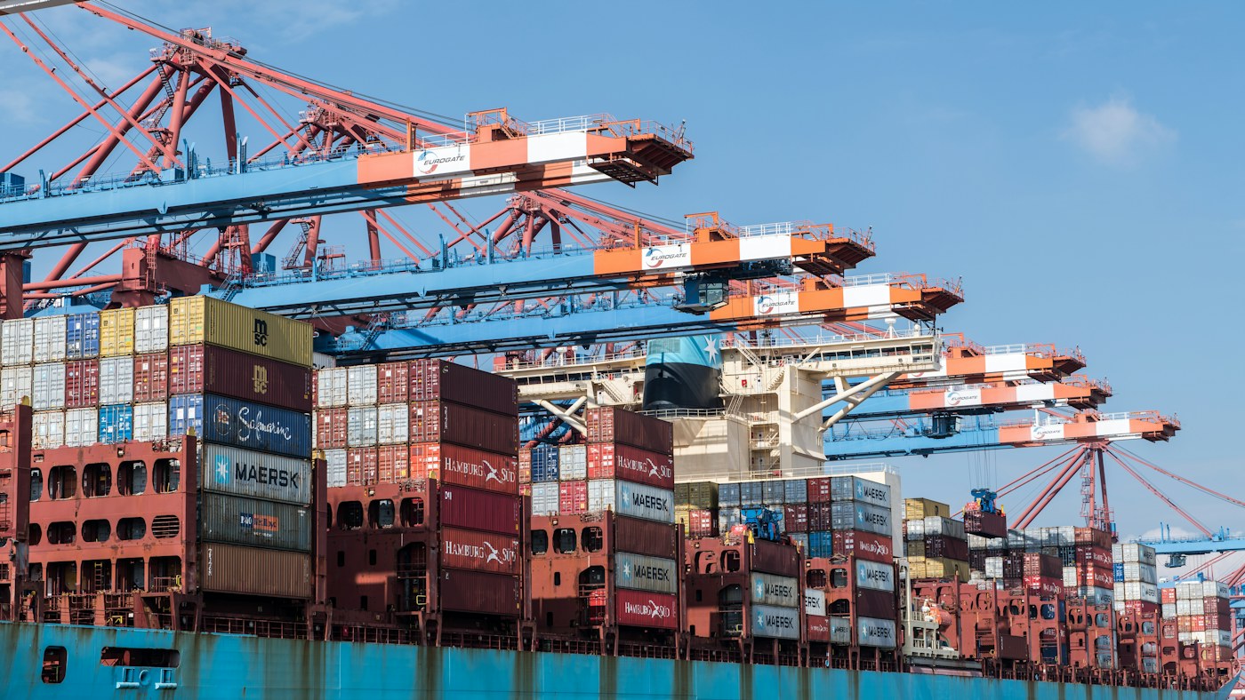 A container ship beneath gantry cranes at a terminal in Hamburg, Germany.